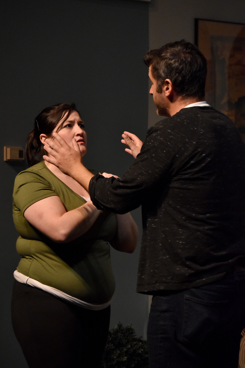 He holds her face in his hands.